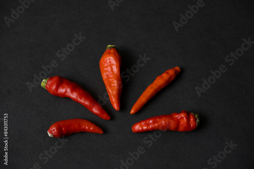 some red chillies on the dark table
