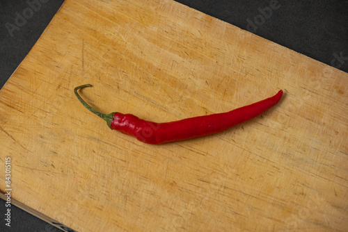 red chilli on a wooden cutting board