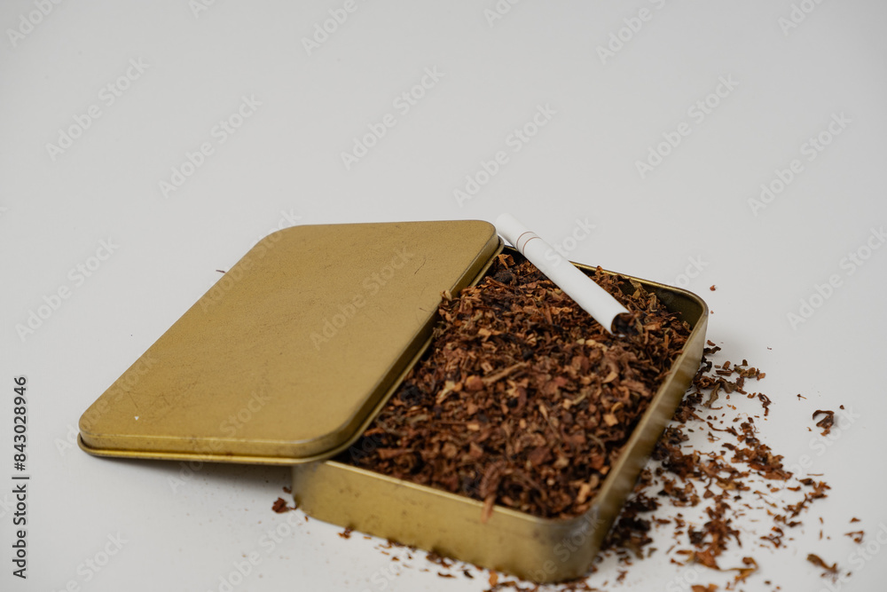 tobacco and some cigarettes around it with a white background tobacco and some cigarettes around it with a white background
