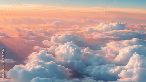 Beautiful aerial view above clouds at sunset. Flying above clouds