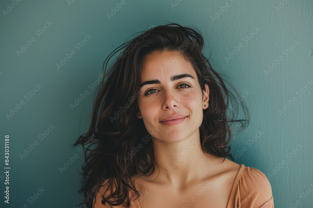 A close up portrait of a young woman with a subtle smile A close up portrait of a young woman with a subtle smile