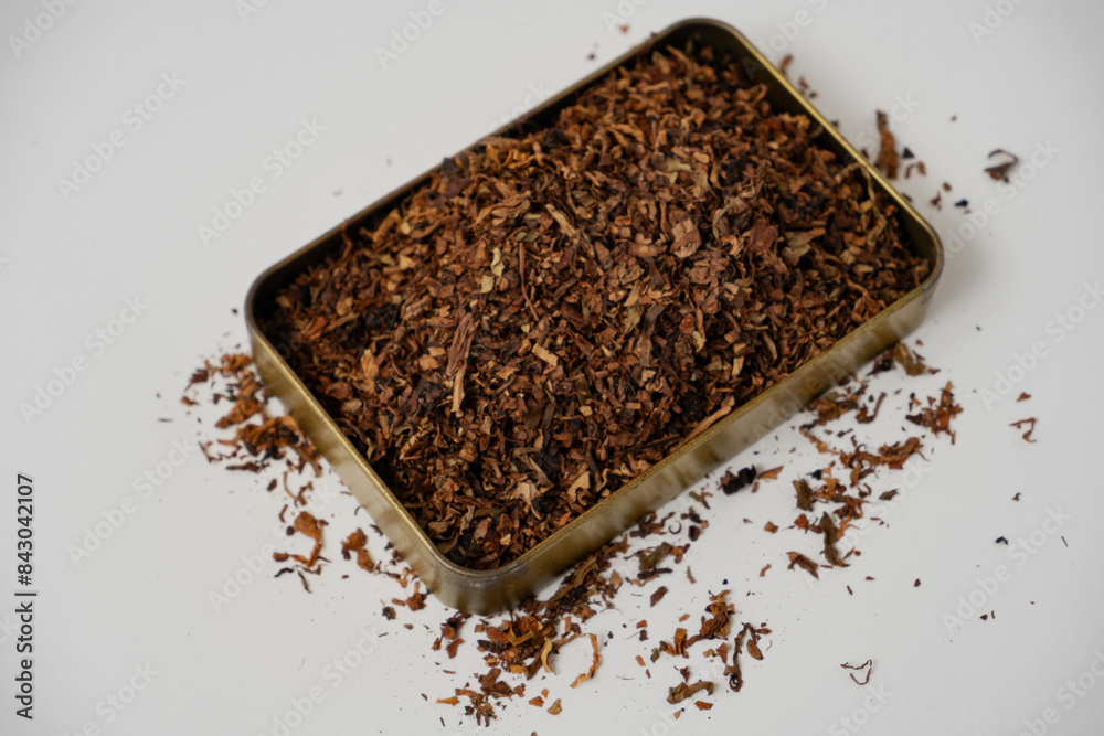 fine tobacco in a gold box with a white background fine tobacco in a gold box with a white background