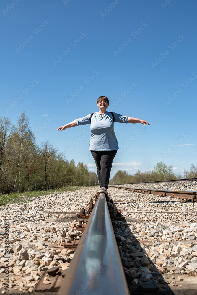 An elderly woman on the railway.