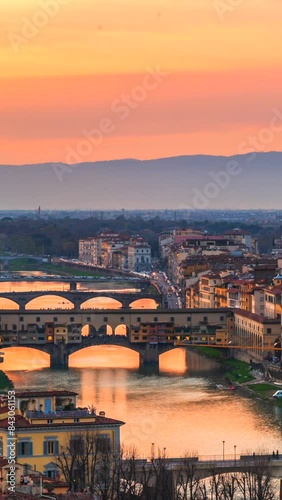 Florence, view of Ponte Vecchio, or Old Bridge, with a beautiful sunset sky, Italy. Vertical video.