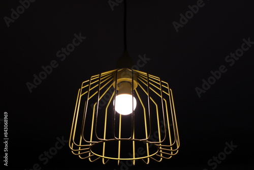 A lamp for illuminating the interior of the room hangs on the ceiling.