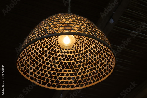 A lamp for illuminating the interior of the room hangs on the ceiling.