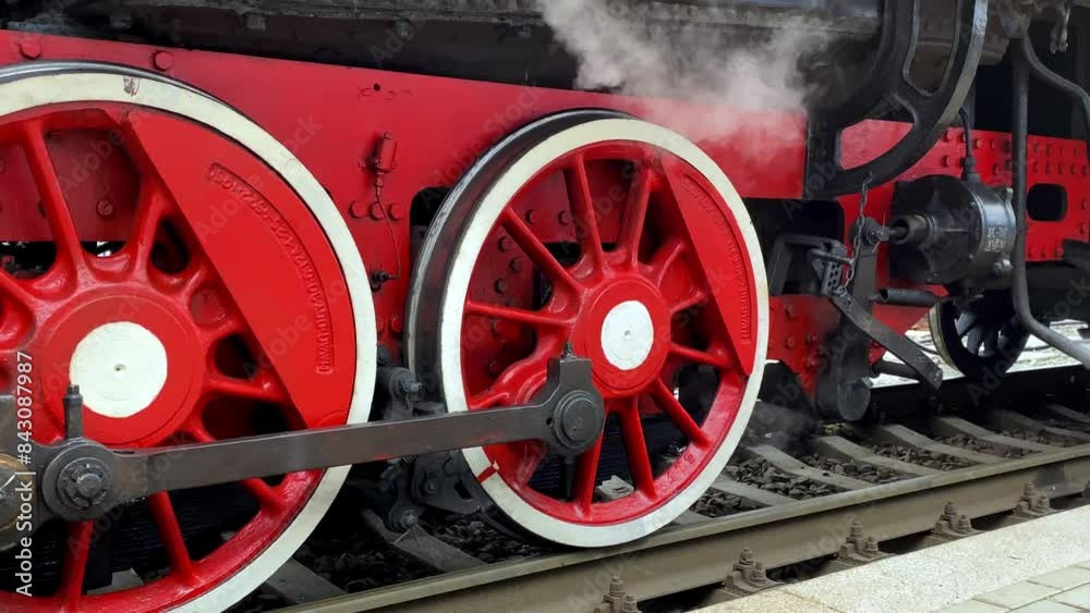 Close-up of a steam locomotive wheels at a railway station. Close-up of a steam locomotive wheels at a railway station.