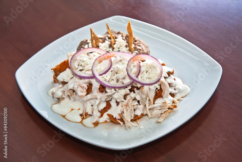Mexican chilaquiles with chicken and spicy sauce traditional breakfast in Mexico, Mexican food
