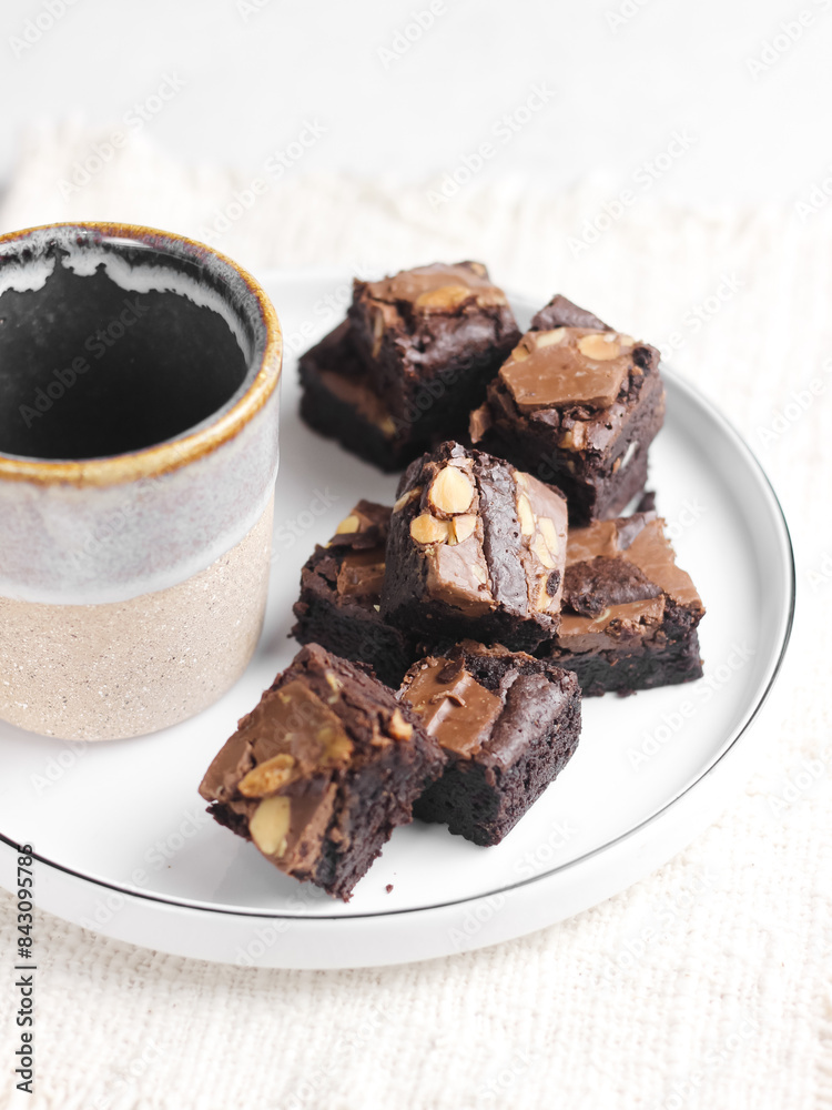 Chocolate brownies squares with chocolate chips and walnuts slices on top. Freshly baked brownies. Best fudgy brownies cakes. Selective focus with shiny and rough texture Chocolate brownies squares with chocolate chips and walnuts slices on top. Freshly baked brownies. Best fudgy brownies cakes. Selective focus with shiny and rough texture