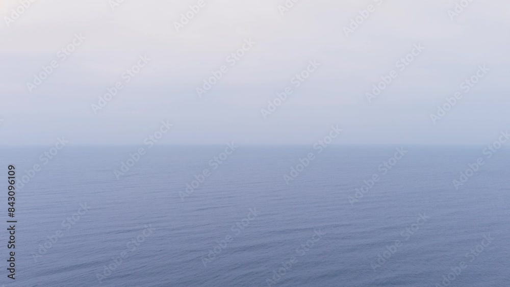 Aerial view of a blue sea water surface. Flight over the waves. Endless ocean view. Vast water expanses. Huge body water in cloudy or foggy weather. Overcast seascape. Aerial view of a blue sea water surface. Flight over the waves. Endless ocean view. Vast water expanses. Huge body water in cloudy or foggy weather. Overcast seascape.