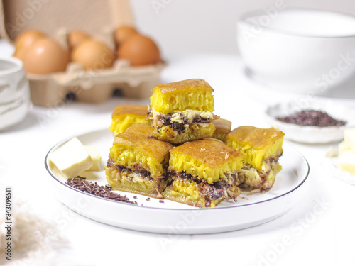 Martabak Coklat Keju , Indonesian Traditional Street Food Named Martabak Manis (Sweet Martabak) with Grated Cheese and Chocolate Meses on WhiteTable