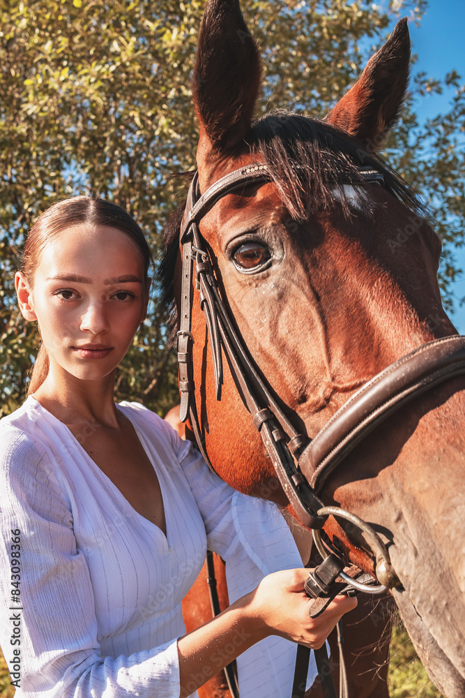 Obraz premium A girl walks with a horse.