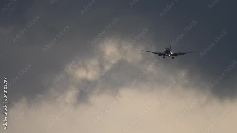 Plane approaching landing at evening. Landing plane at cloudy sunset Plane approaching landing at evening. Landing plane at cloudy sunset