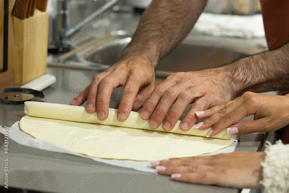 kneading puff pastry with hands to make homemade croissants. preparing desserts kneading puff pastry with hands to make homemade croissants. preparing desserts