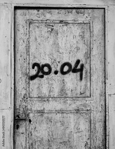 Save the Date. Mysterious Closed Door Frame with Numbers 20.04 . Remember the Time. © Miki