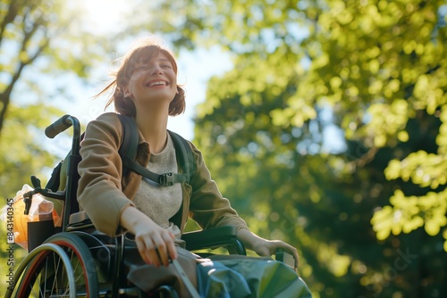 A cheerful young woman enjoying a sunny day outdoors in her wheelchair, representing positivity, rehabilitation, and a healthy lifestyle.