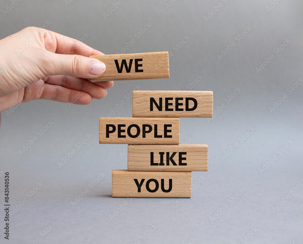 Hiring symbol. Wooden blocks with words We need People like You. Businessman hand. Beautiful grey background. Business and Hiring concept. Copy space. Hiring symbol. Wooden blocks with words We need People like You. Businessman hand. Beautiful grey background. Business and Hiring concept. Copy space.