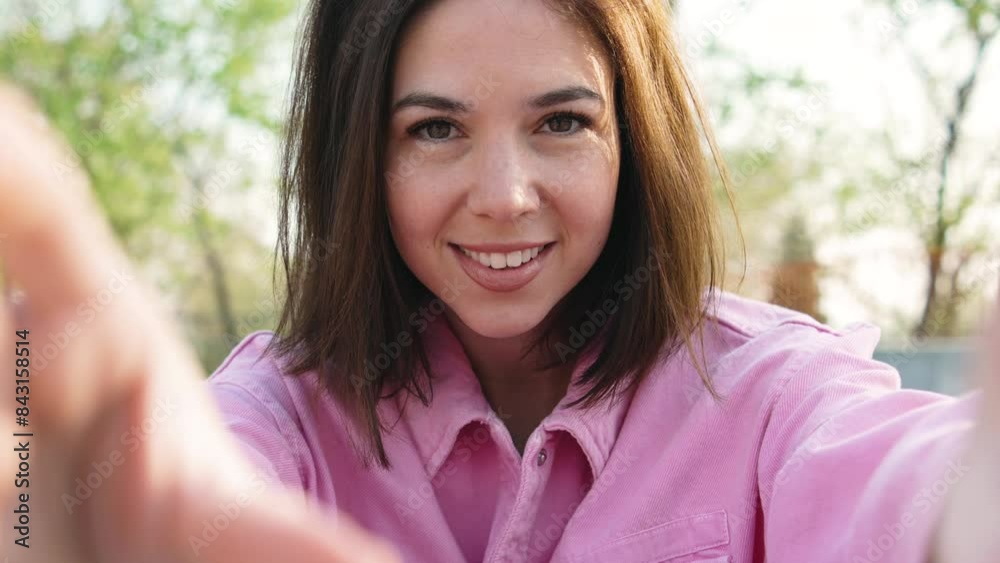 Happy brunette woman blogger sets up video camera for making video blog on sunset outdoors pov Happy brunette woman blogger sets up video camera for making video blog on sunset outdoors pov