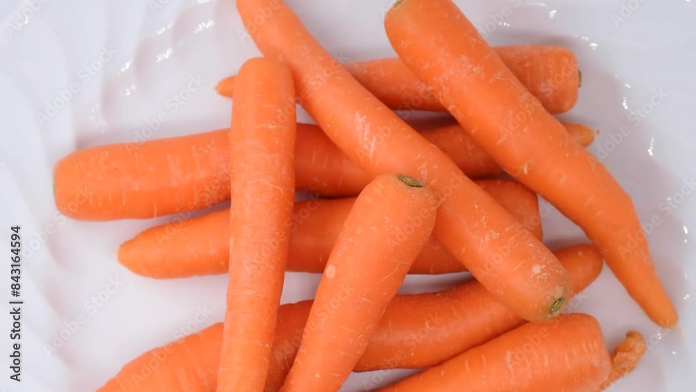 pile of whole natural carrots on white plate,close-up,rotating video pile of whole natural carrots on white plate,close-up,rotating video