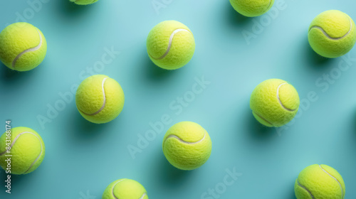 pattern of tennis balls in a creative pattern on light teal background © Belho Med