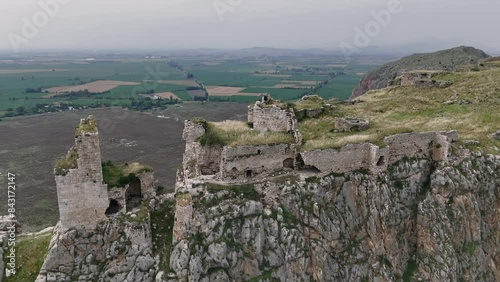Aerial drone footage showcases the awe-inspiring ruins of Anavarza Castle, perched atop a mountain in Adana, Turkey. Witness the intricate architecture and engineering marvel of this ancient fortress photo