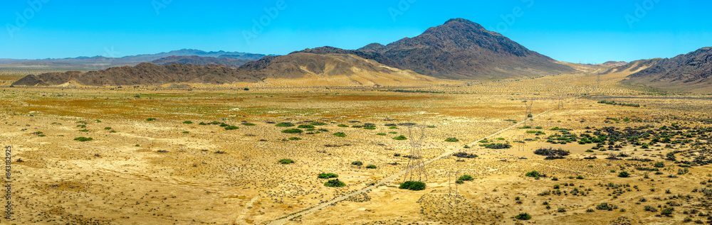 Naklejka premium Aerial panoramic view of mountains, Mohave desert and sand drifts against hillsides in the Cronese Valley 