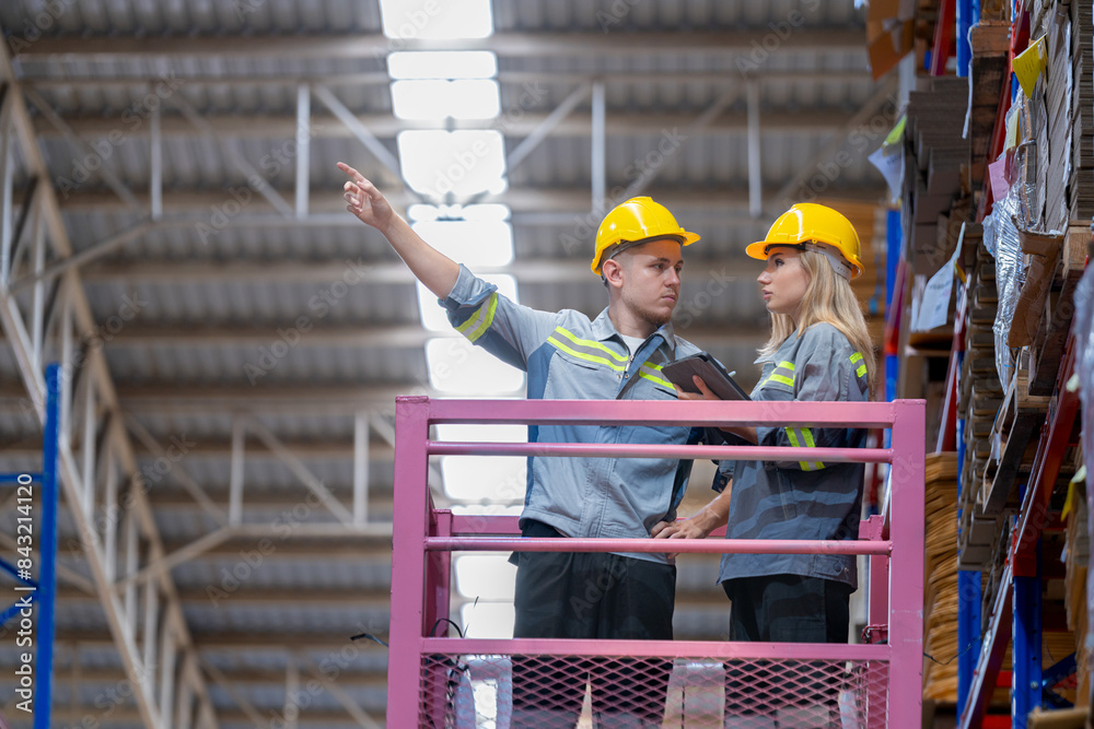 workers man and woman using a hydraulic scissor lift to check stock near the shelves warehouse. industry factory warehouse. Worker Screening Package In Warehouse. workers man and woman using a hydraulic scissor lift to check stock near the shelves warehouse. industry factory warehouse. Worker Screening Package In Warehouse.