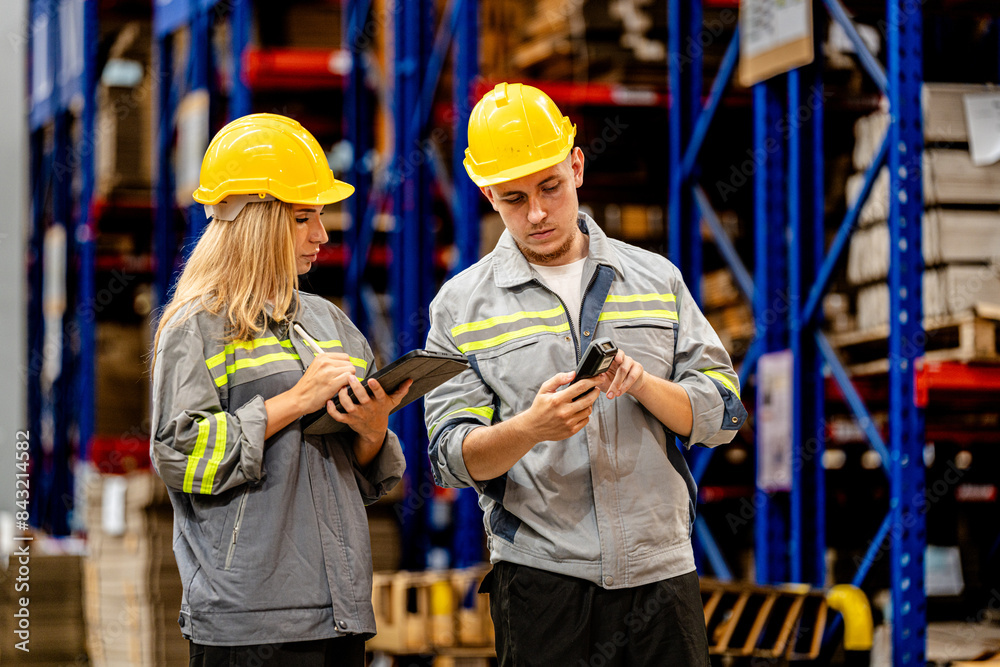 man and woman worker walking and checking stock for shipping. Female inspecting the store factory. Logistics employees holding folders at on site warehouse area for shipping transportation. man and woman worker walking and checking stock for shipping. Female inspecting the store factory. Logistics employees holding folders at on site warehouse area for shipping transportation.