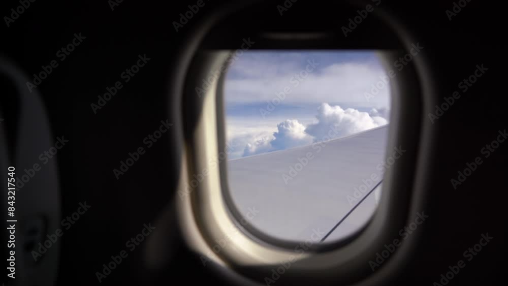 Looking through window aircraft during flight in wing. Airplane flight. Wing of an airplane flying above the clouds. View from the window of the plane. Aircraft. Traveling. Looking through window aircraft during flight in wing. Airplane flight. Wing of an airplane flying above the clouds. View from the window of the plane. Aircraft. Traveling.