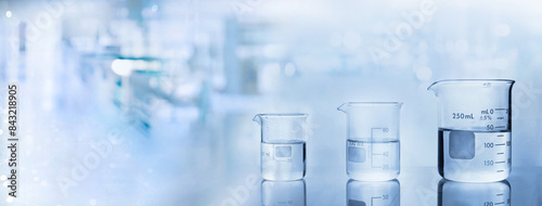 beakers with water in chemistry science lab banner background