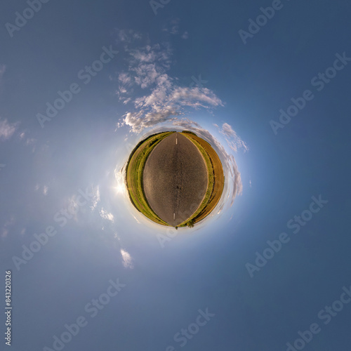 simple tiny planet without buildings in blue sky with beautiful clouds. Transformation of spherical panorama 360 degrees. Spherical abstract aerial view. Curvature of space.