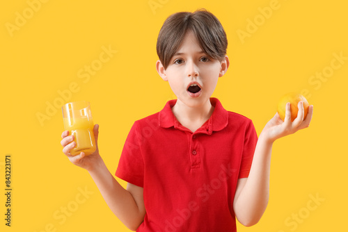 Shocked little boy with ora...