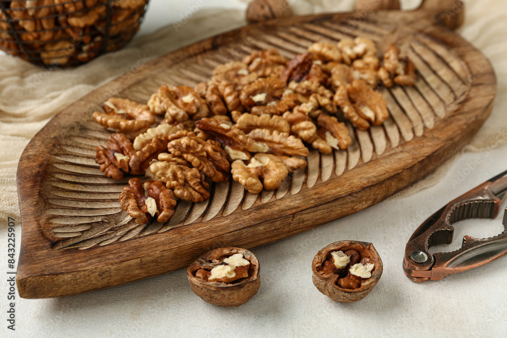 Wooden board of tasty walnuts on white background Wooden board of tasty walnuts on white background