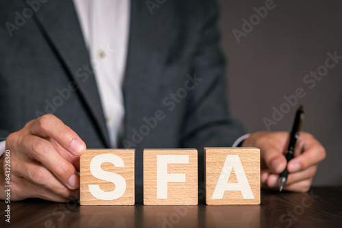 There is wood cube with the word SFA. It is an abbreviation for Sales Force Automation as eye-catching image.