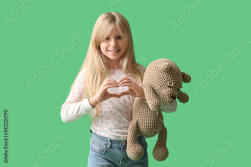 Cute little girl with plush...