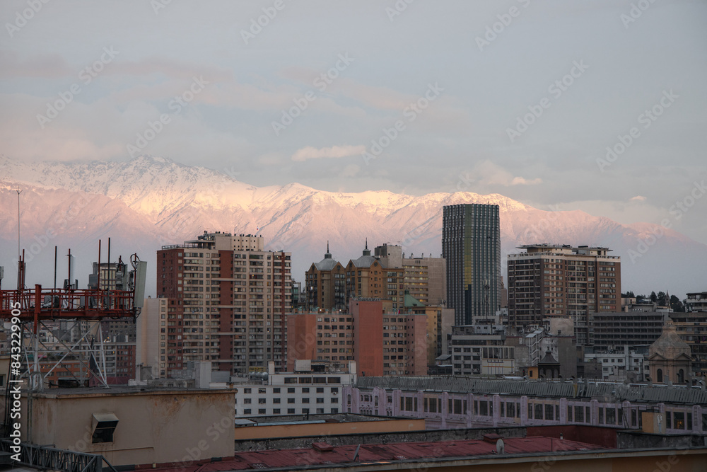 Sunset with a view from above to the city of Santiago, Chile, with a view of the Andes mountains.