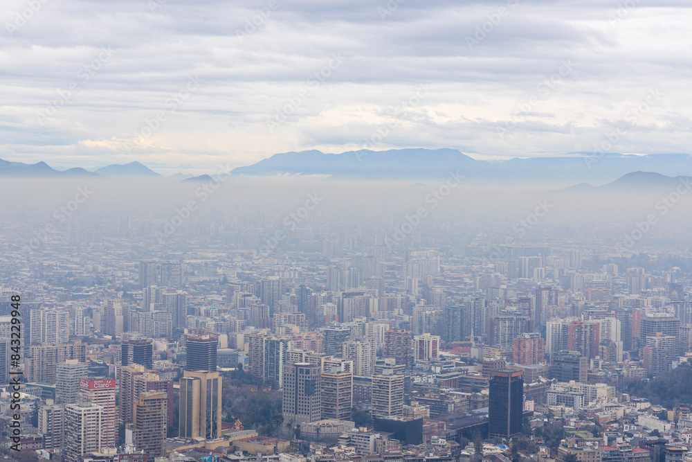 Sunset with a view from above to the city of Santiago, Chile, with a view of the Andes mountains.
