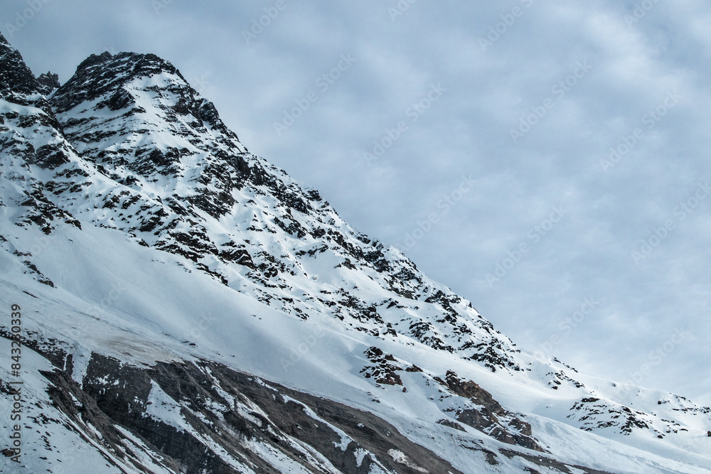 A freezing day high in the Andes Mountains in Chile, with mountains covered in snow.