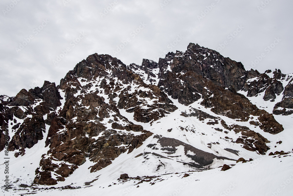 A freezing day high in the Andes Mountains in Chile, with mountains covered in snow.