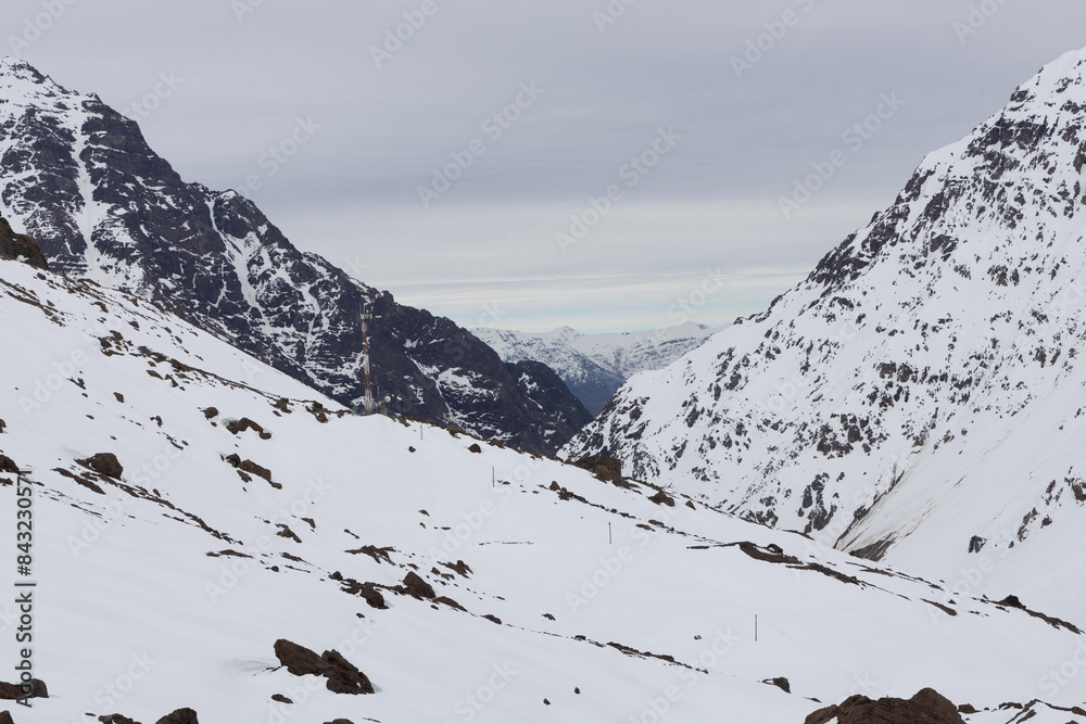 A freezing day high in the Andes Mountains in Chile, with mountains covered in snow.