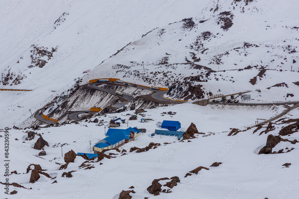 A freezing day high in the Andes Mountains in Chile, with mountains covered in snow.