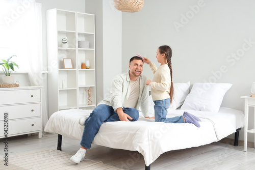 Little girl brushing her fa...