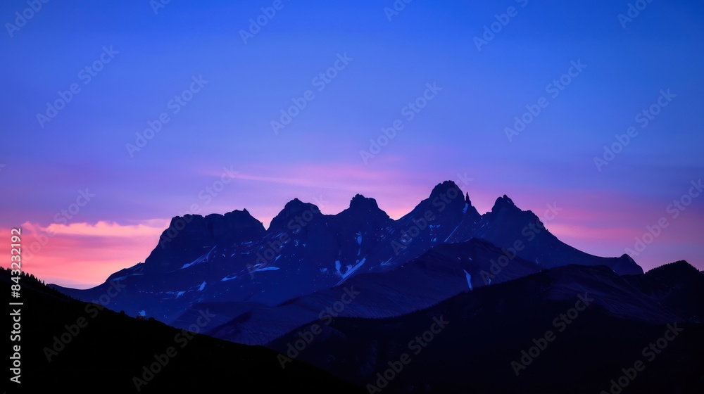 Peak Majestic Rocky Mountain is snowy with a clear morning sky with a crescent moon in the background. Peak Majestic Rocky Mountain is snowy with a clear morning sky with a crescent moon in the background.