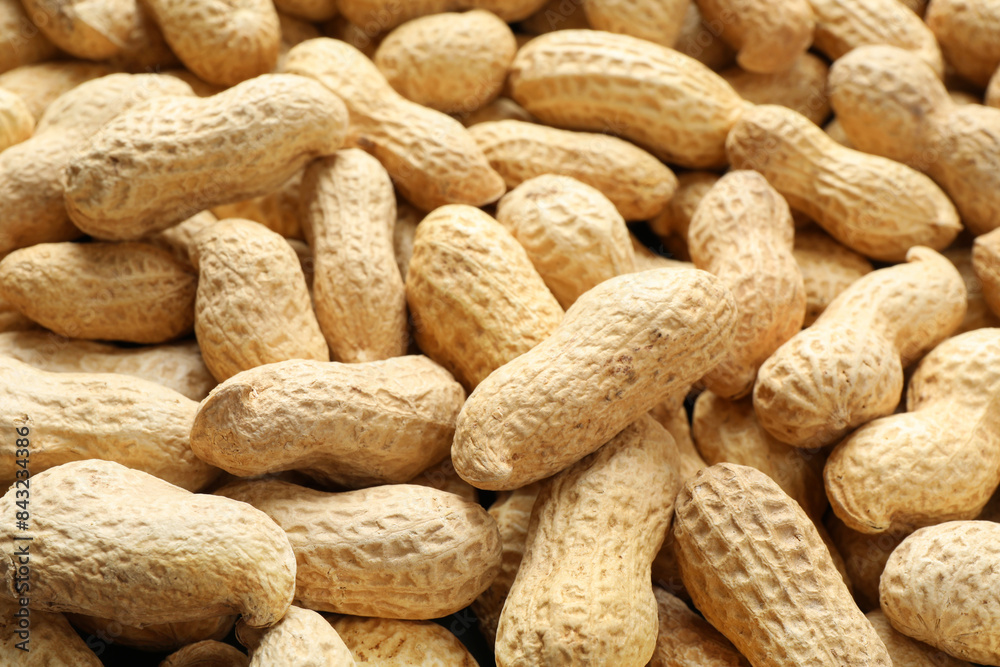 Many fresh unpeeled peanuts as background, closeup Many fresh unpeeled peanuts as background, closeup
