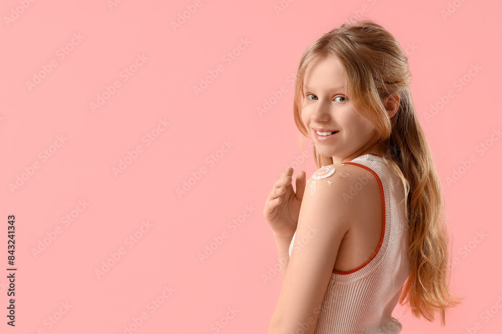 Beautiful girl with sunscreen cream in shape of sun on her shoulder on pink background Beautiful girl with sunscreen cream in shape of sun on her shoulder on pink background