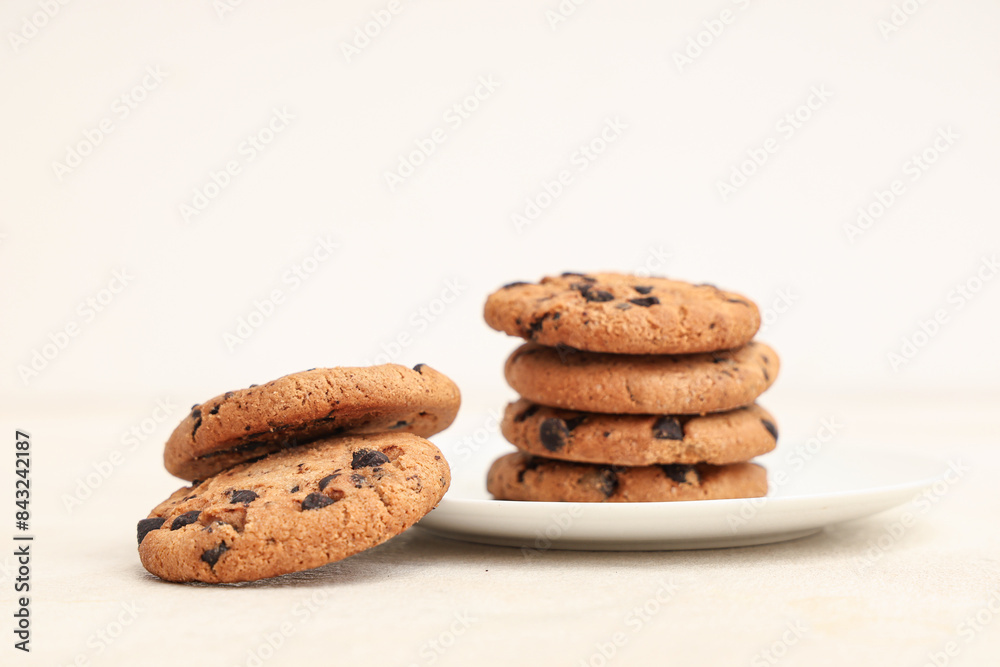 Plate of sweet cookies with chocolate chips on white background Plate of sweet cookies with chocolate chips on white background