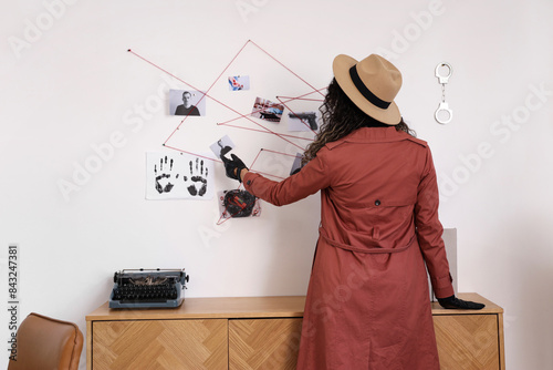 Female spy near crime board...
