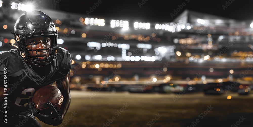 Fototapeta premium Determined Football Player in Black Uniform Holding Ball