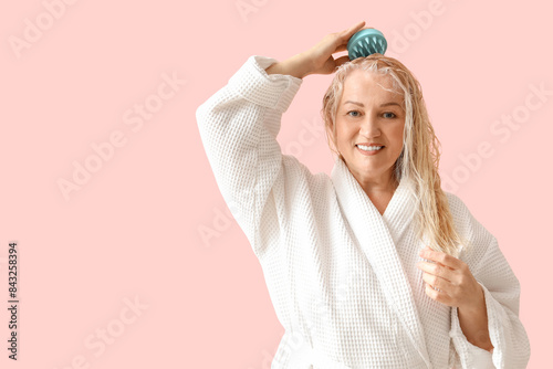 Mature woman using hair sca...