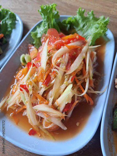 papaya salad on dish photo